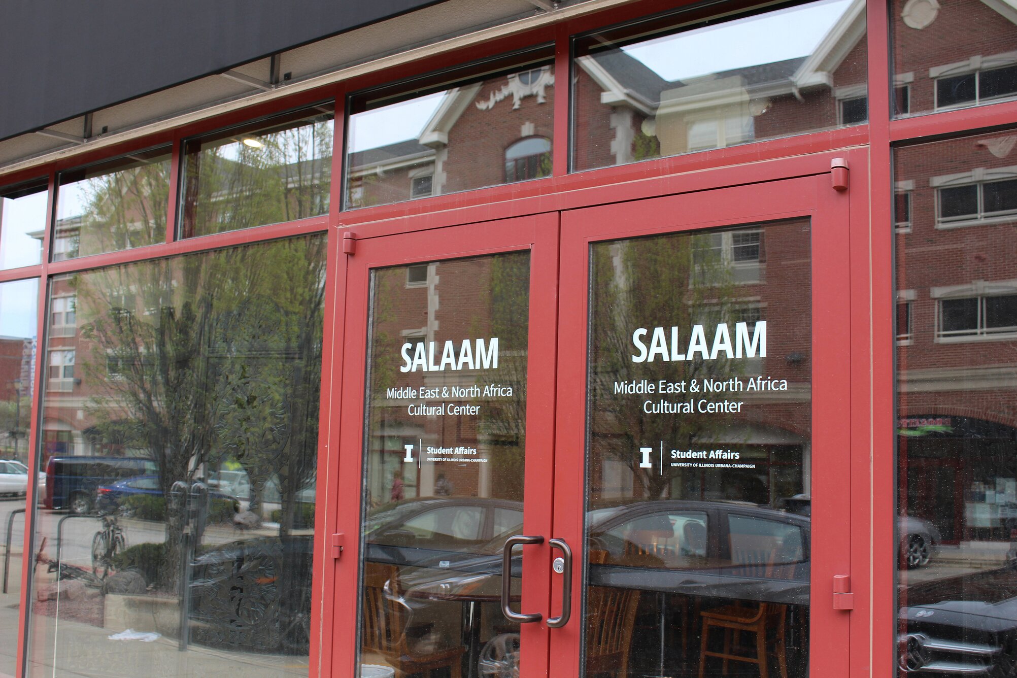 External view of the main entrance doors to the Salaam MENA Cultural Center with reflections in windows