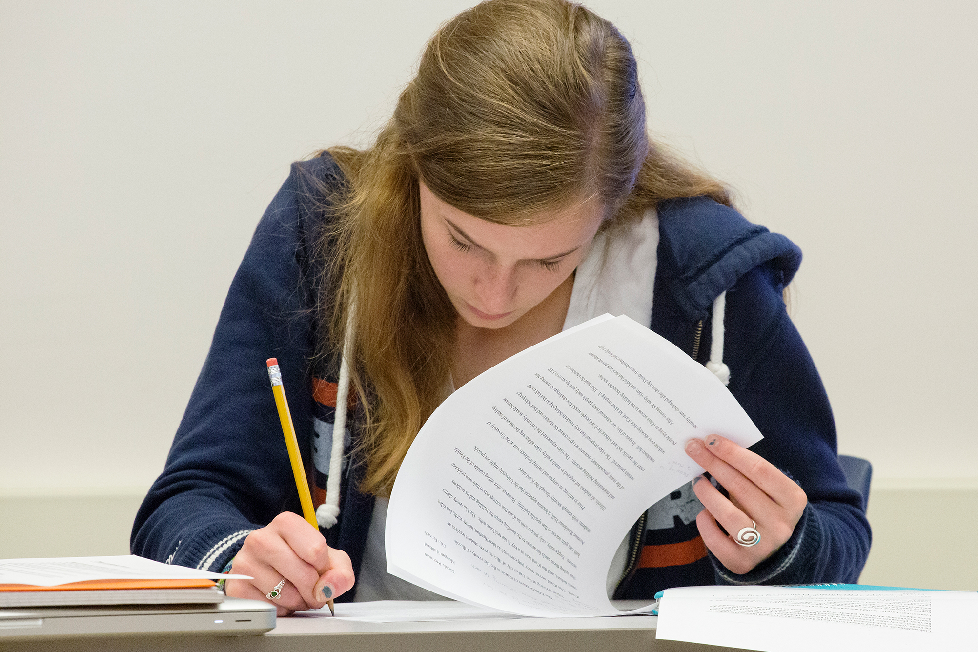 Female student with pencil taking a paper test