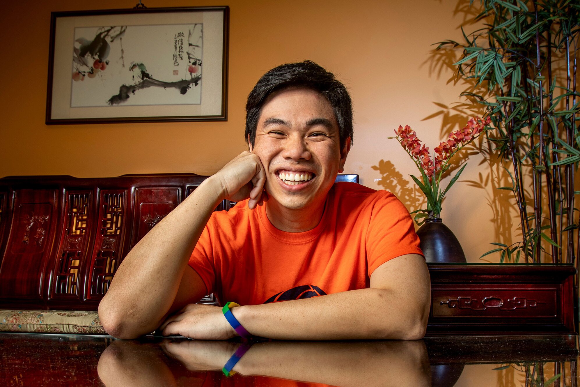 Male student smiling and posing in the Asian American Cultural Center